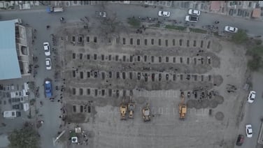 Drone shows excavators digging graves for victims of Iran school attack