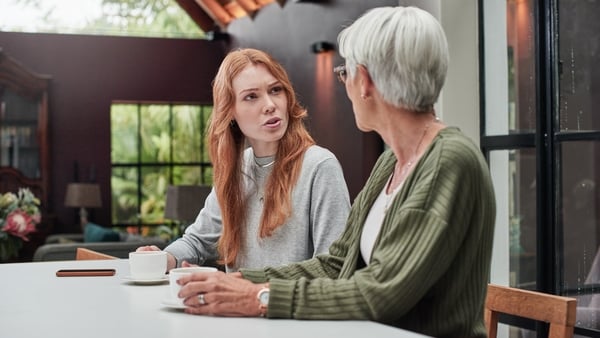 adult mother and daughter having coffee together