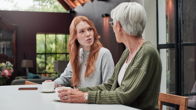 adult mother and daughter having coffee together