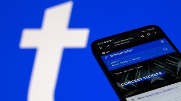 The Ticketmaster mobile web page displays on a mobile phone with the company's branding icon visible in the background. (Photo by Jonathan Raa/NurPhoto)