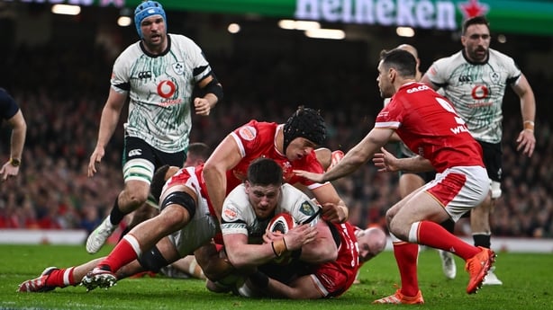 Joe McCarthy of Ireland is tackled by Wales players, from left, Dafydd Jenkins, Taulupe Faletau, Ben Thomas and Tomos Williams during the Guinness Six Nations Rugby Championship match between Wales and Ireland at the Principality Stadium in Cardiff, Wales.