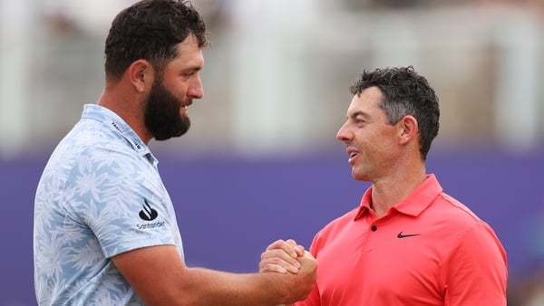Jon Rahm of Spain and Rory McIlroy of Northern Ireland shake hands on the 18th green following their round on Day One of the DP World Tour Championship on the Earth Course at Jumeirah Golf Estates on November 16, 2023 in Dubai, United Arab Emirates.