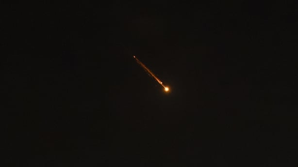 Rocket trails are seen in the sky above Tel Aviv