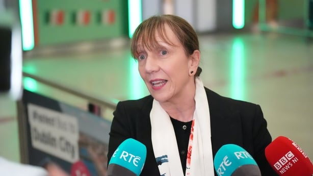 Gina Quinn being interviewed by reporters