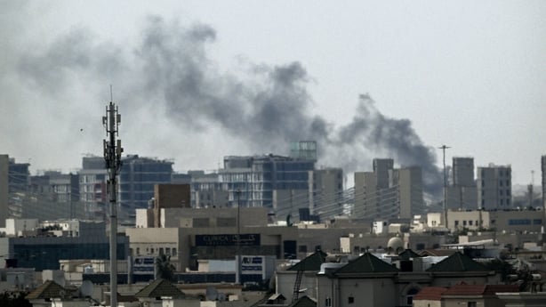A plume of smoke rises over buildings in Doha on March 5,