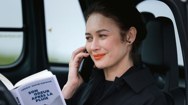 Olga Kurylenko on the phone in The Three Urns