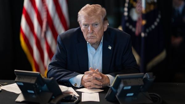Donald Trump sits at a table monitoring military operations during Operation Epic Fury against Iran