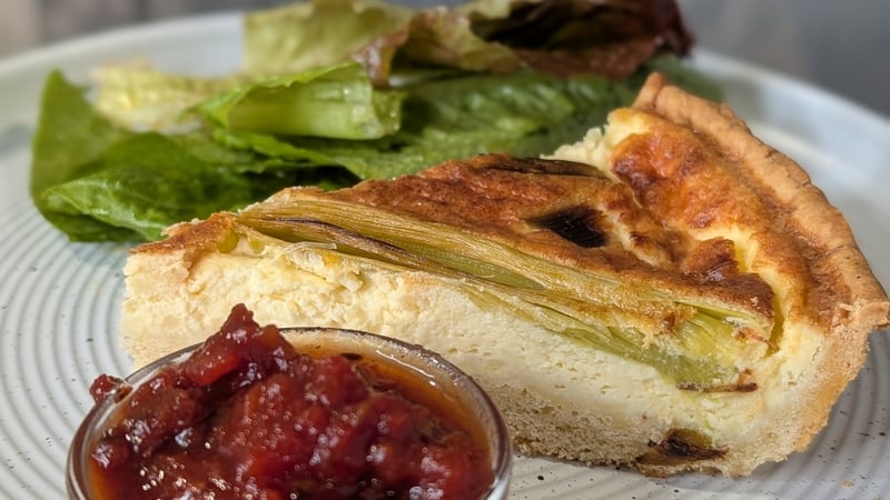 A slice of quiche with a side of relish