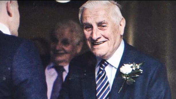 Liam Farrell in a suit, smiling