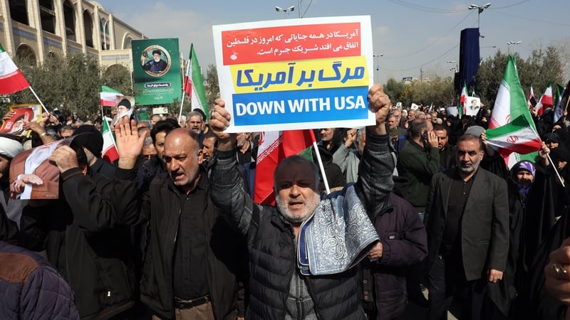 Iranians hold placards and wave flags as they take part in an anti US-Israel demonstration in Tehran