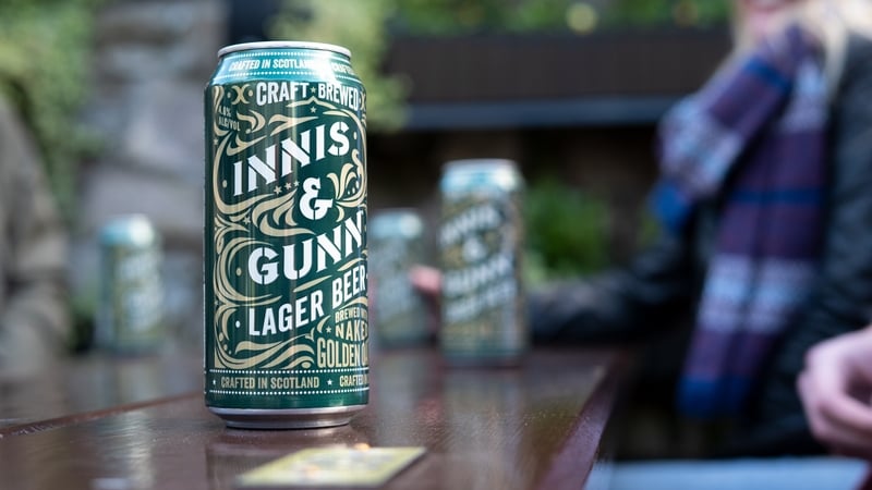 A can of beer on a table with Innis & Gunn branding