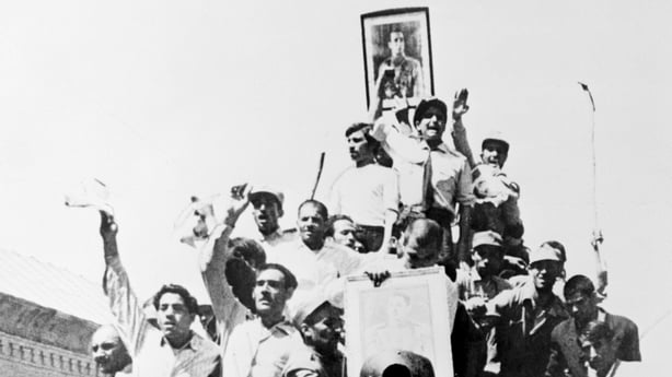  A portrait of the Shah is carried triumphantly atop an Iranian Army tank patrolling the streets of Teheran after the coup that overthrew the regime of Premier Mohammed Mossadegh. The weepy Premier is now in the hands of the army and may be tried for treason. The Shah has returned and has been given