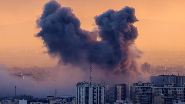 A plume of smoke rises after a strike on the Iranian capital Tehran,
