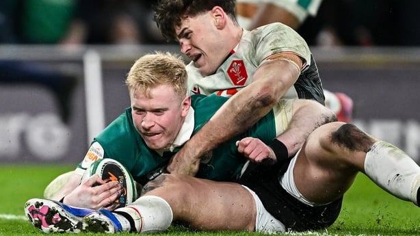 6 March 2026; Jamie Osborne of Ireland scores his side's fourth try despite the efforts from Eddie James of Wales during the Guinness 6 Nations Rugby Championship match between Ireland and Wales at the Aviva Stadium in Dublin. Photo by Seb Daly/Sportsfile