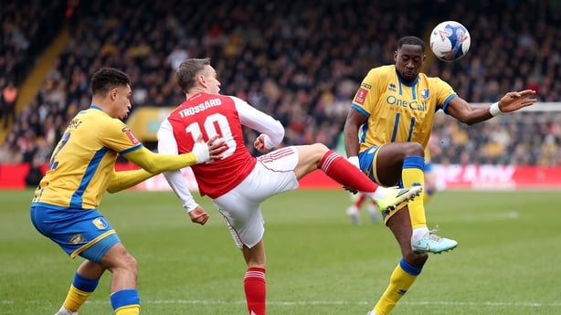 MANSFIELD, ENGLAND - MARCH 07: Leandro Trossard of Arsenal battles for possession with Kyle Knoyle and Lucas Akins of Mansfield Town during the Emirates FA Cup Fifth Round match between Mansfield Town and Arsenal at One Call Stadium on March 07, 2026 in Mansfield, England. (Photo by Alex Pantling/Ge