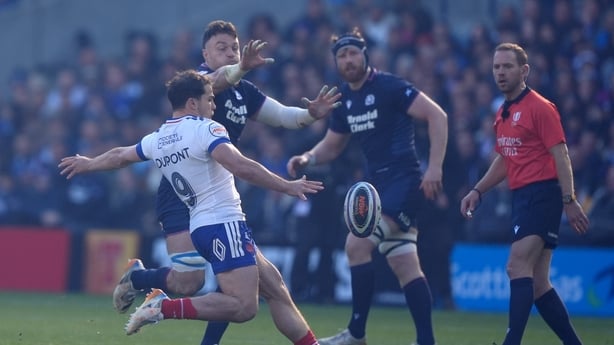 Scotland's Jack Dempsey (rear) attempts to charge down a kick from France's Antoine Dupont