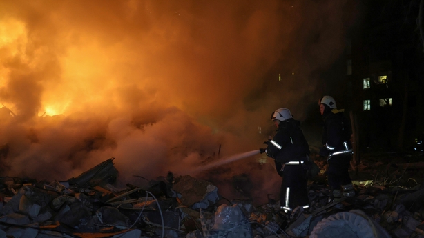 Rescuers extinguish a fire amid the ruins of the entrance of a five-storey residential building destroyed by a Russian ballistic missile in the Kyivskyi district of Kharkiv, Ukraine, on March 7, 2026. At least eight people are killed in the strike on Saturday night, and ten others are injured, inclu