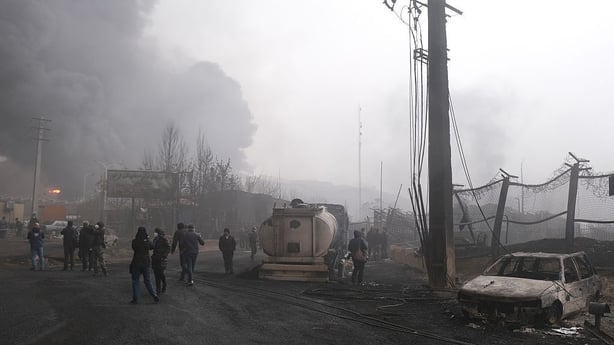 Plumes of smoke rise over the oil depot tanks hit by joint Israel-US over night in a station north west of the capital on 8 March
