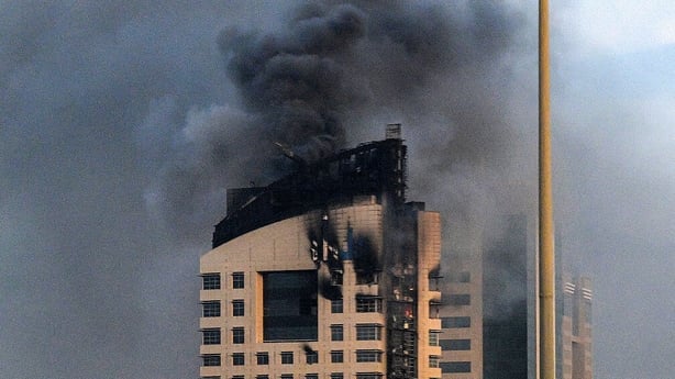 Smoke rises from a high-rise building following a drone attack in Kuwait city