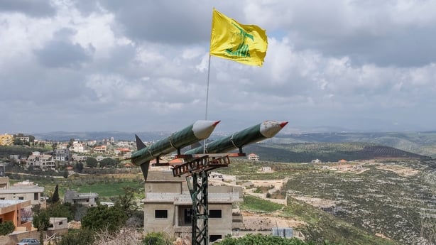 A Hezbollah flag flies over some of its missiles in Lebanon