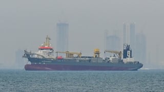 A commercial ship is viewed anchored off the coast of the United Arab Emirates