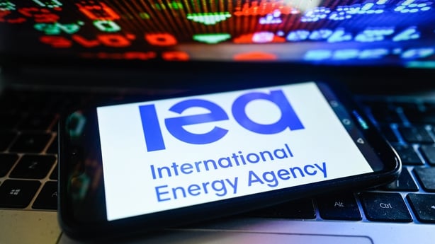 International Energy Agency logo displayed on a smartphone with stock market percentages in the background. (Photo Illustration by Omar Marques/SOPA Images/LightRocket via Getty Images)