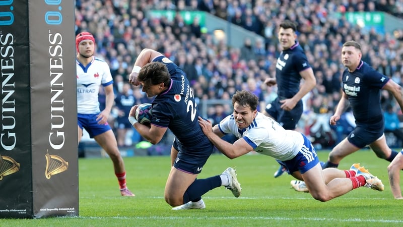 EDINBURGH, SCOTLAND - MARCH 07: Tom Jordan of Scotland scores his team's seventh try whilst under pressure from Antoine Dupont of France during the Guinness Six Nations 2026 match between Scotland and France at Scottish Gas Murrayfield on March 07, 2026 i