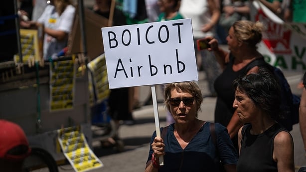A protestor holds a banner that reads ''Boicot Airbnb'' during an anti-tourism demonstration in Barcelona, Catalunya, Spain, on June 15, 2025. (Photo by Manu Alvarez/NurPhoto via Getty Images)