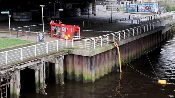 Fire crews pump water from the River Clyde after a fire at Glasgow Central train station