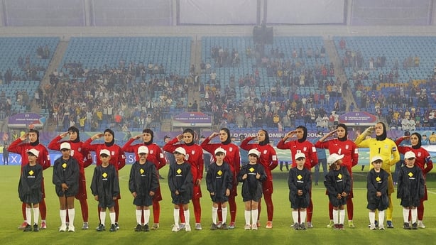 Iranian players salute the national anthem before their Asian Cup match against Australia