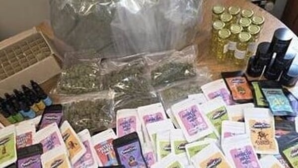 Image shows a selection of colourful drug packets arranged on a table.