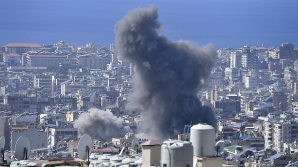 Smoke rises among the residential buildings following the Israeli attack on Dahieh region in Beirut