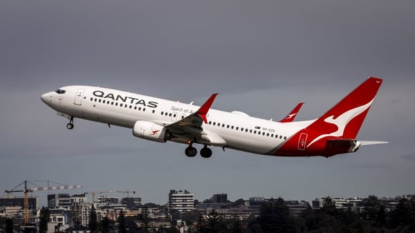 A Qantas Airways Boeing 737 aircraft takes off from Sydney International Airport