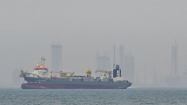 A commercial ship is viewed anchored off the coast of the United Arab Emirates, in the Strait of Hormuz, Dubai