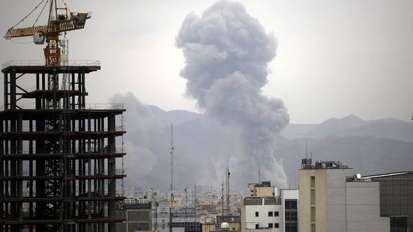 Smoke rises among residential buildings in Tehran