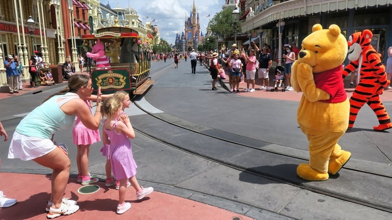 Young guests enjoy seeing Winnie The Pooh, and Tiggerat the Magic Kingdom at Walt Disney World, in Lake Buena Vista, Florida, on May 17, 2021.