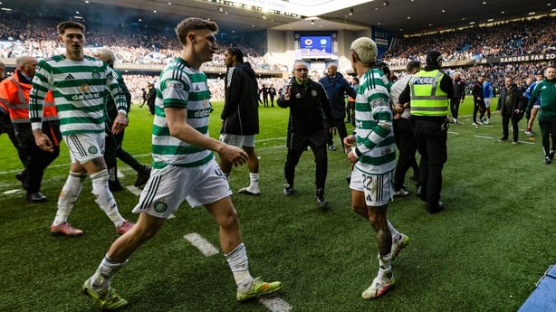 Celtic's Tomas Cvancara, Dane Murray, manager Martin O'Neill and Julian Araujo leave the pitch as fans storm the pitch at Ibrox