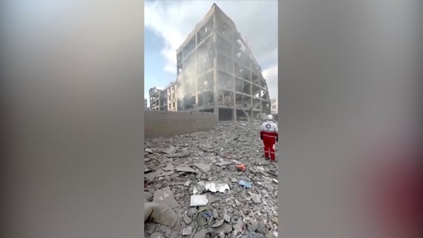 Rescuers search through rubble after air strikes in Tehran