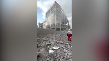 Rescuers search through rubble after air strikes in Tehran