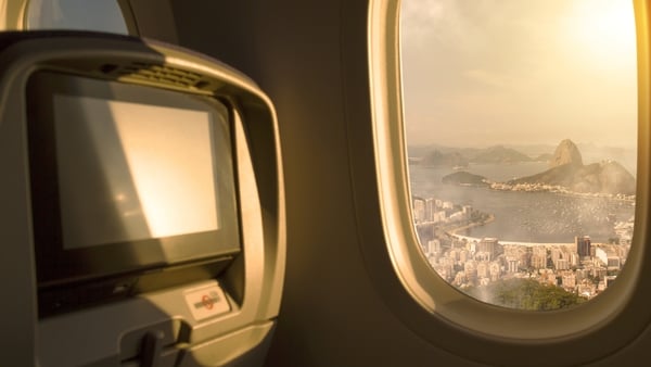Sunrise aerial view of Rio de Janeiro from a porthole window of an airplane