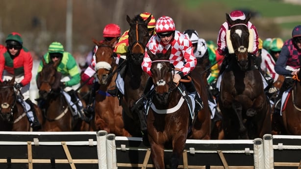 Jockey James Bowen on Jingko Blue clear a fence in the BetMGM Cup Handicap Hurdle on the second day of the Cheltenham Festival at Cheltenham Racecourse, in Cheltenham, western England on March 11, 2026. (Photo by Adrian Dennis / AFP)