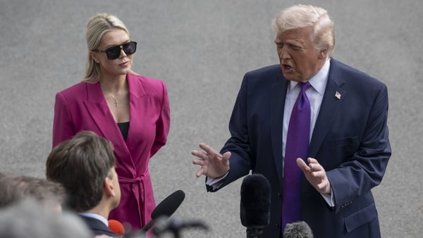WASHINGTON DC, UNITED STATES - MARCH 11 : United States President Donald Trump (R) and White House press secretary Karoline Leavitt (L) are seen during the his departure the White House en route Hebron, Kentucky on March 11, 2026, in Washington DC, United