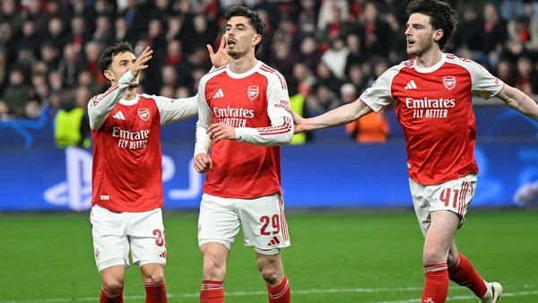 Kai Havertz (C) reacts after scoring from the penalty spot with his teammates Arsenal's English midfielder #41 Declan Rice (R) and Arsenal's Spanish defender #36 Martin Zubimendi during the UEFA Champions League, Last 16, first-leg football match Bayer 04