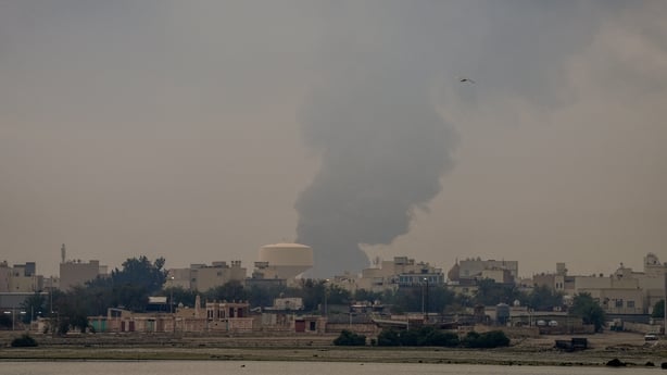 A plume of smoke rises after a reported Iranian strike on fuel tanks in Muharraq