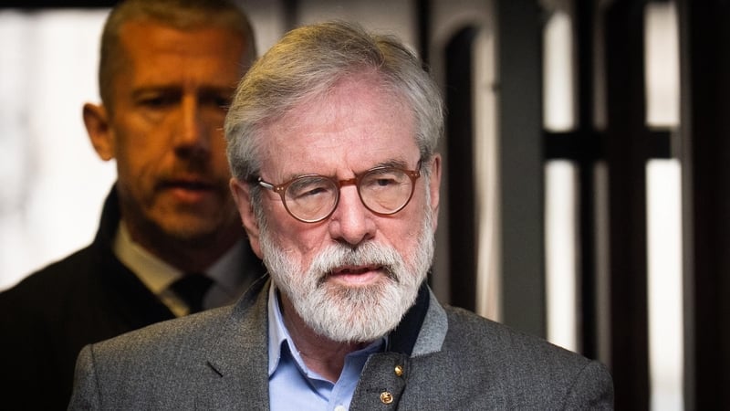 This photograph shows former sinn fein leader gerry adams arriving at a court in london wearing glasses, a second unnamed man can be see in the background