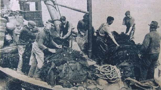 Black and white image of fishermen on a boat