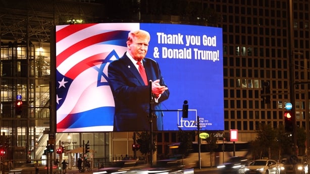 A billboard depicting an image of US President Donald Trump with a message thanking him, is displayed on the side of a building in the Israeli coastal city of Tel Aviv