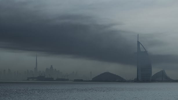a large cloud of smoke hung over a central area of Dubai