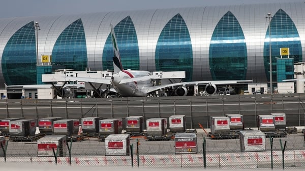 A plane parked on the apron of a modern airport in the Middle East - Dubai