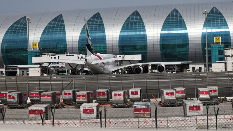 A plane parked on the apron of a modern airport in the Middle East - Dubai